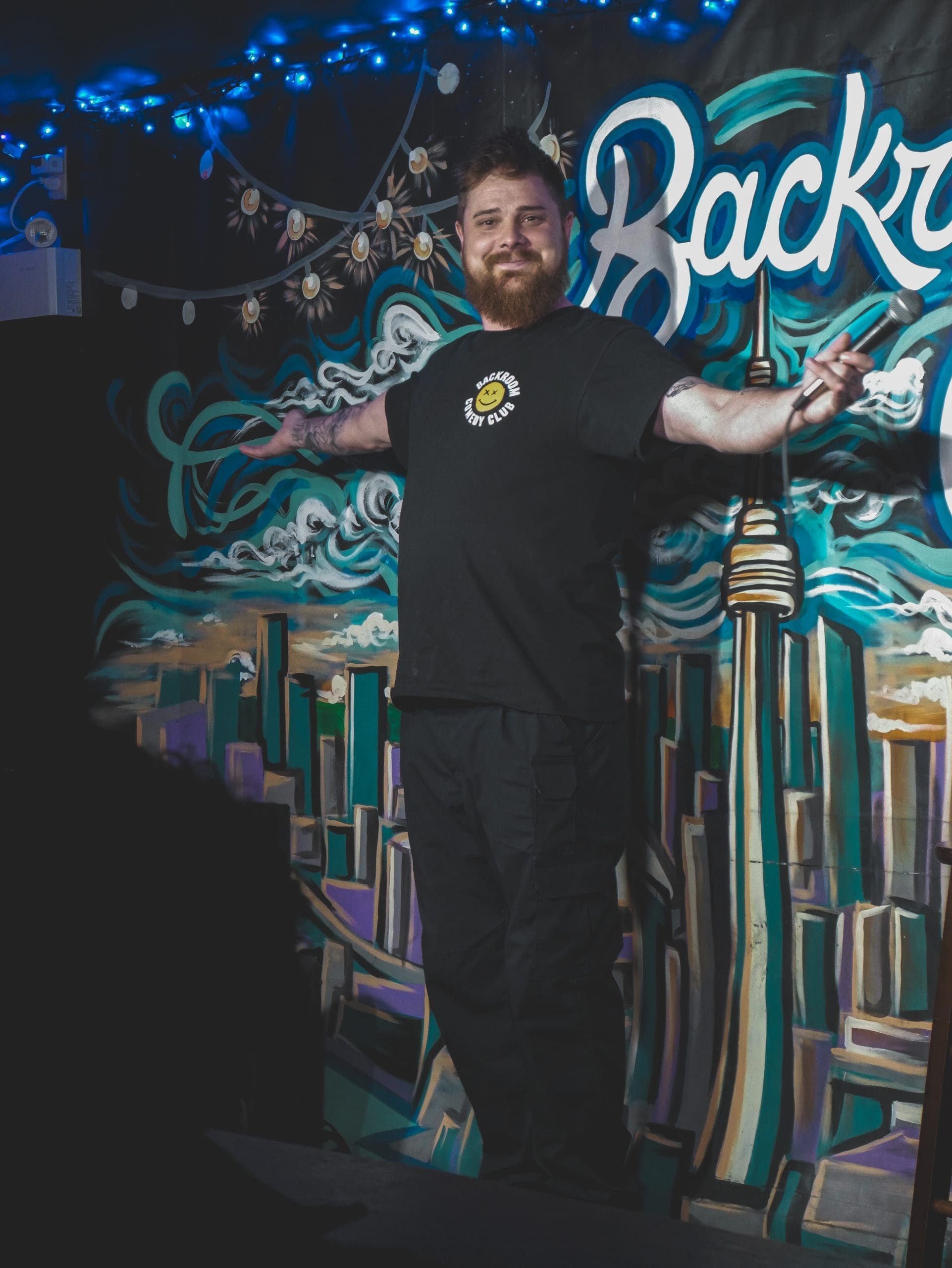 DK Collins on stage at Backroom Comedy Club